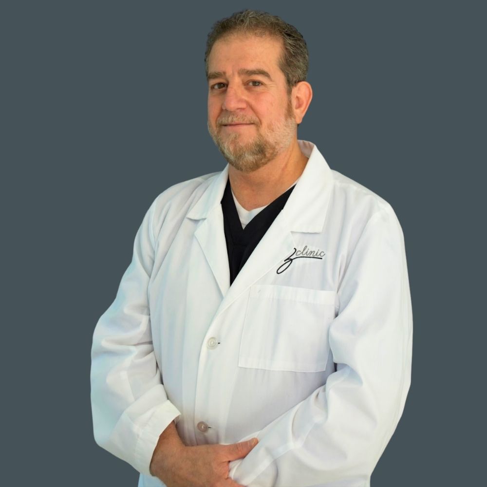 Portrait of Dr. El-Bakri in a white ZClinic coat